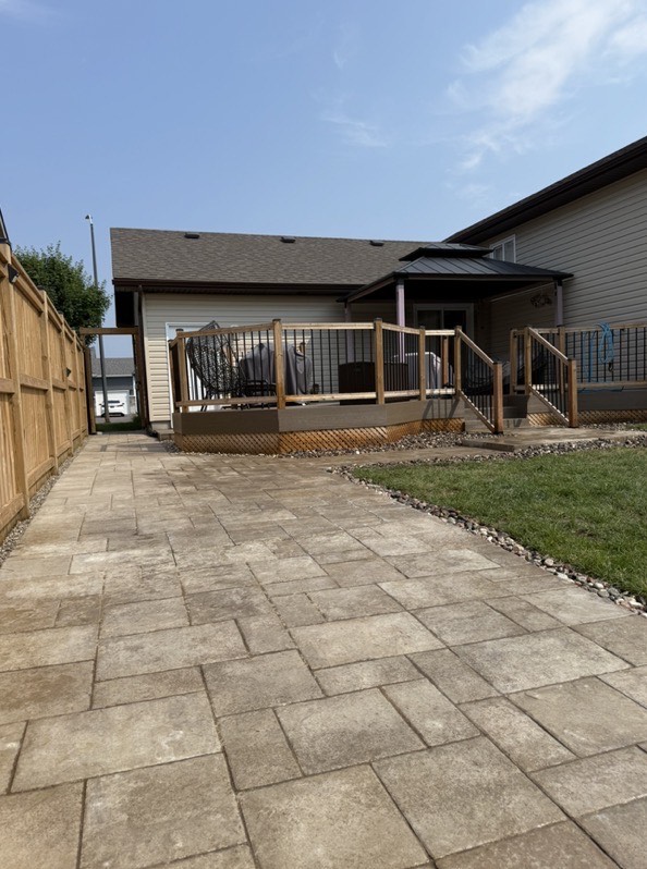 Bag of Grass Seed laying on grass beside spreader